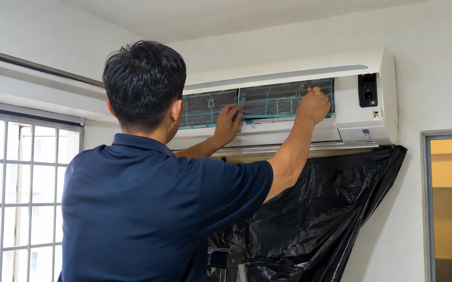 Aircon technician carrying out general servicing in Singapore.