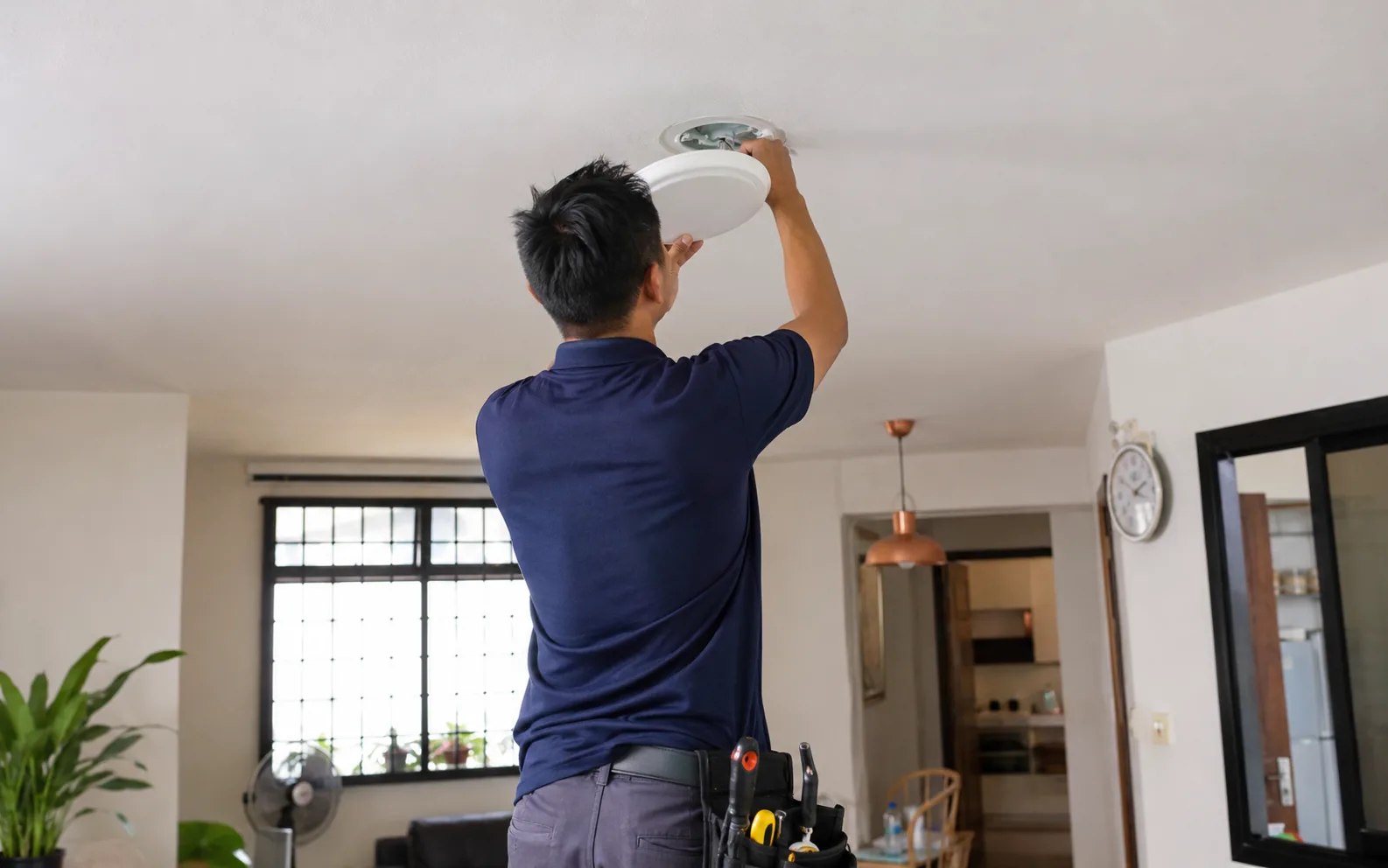 Technician carrying out condo maintenance in Singapore.