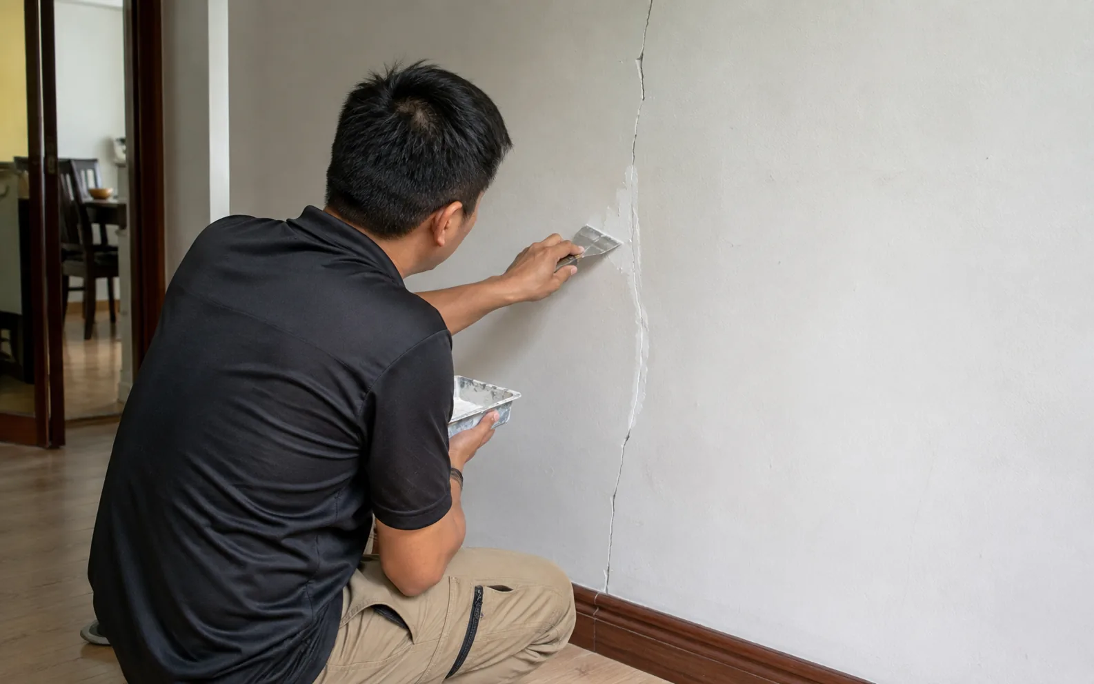Technician sealing a crack in Singapore.