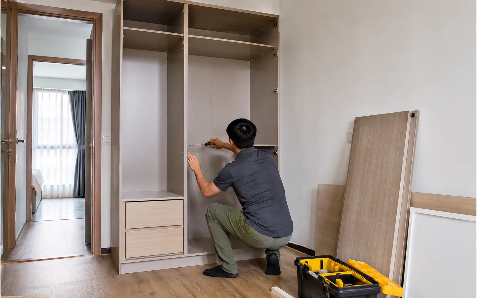 Technician dismantling or reassembling furniture in Singapore.