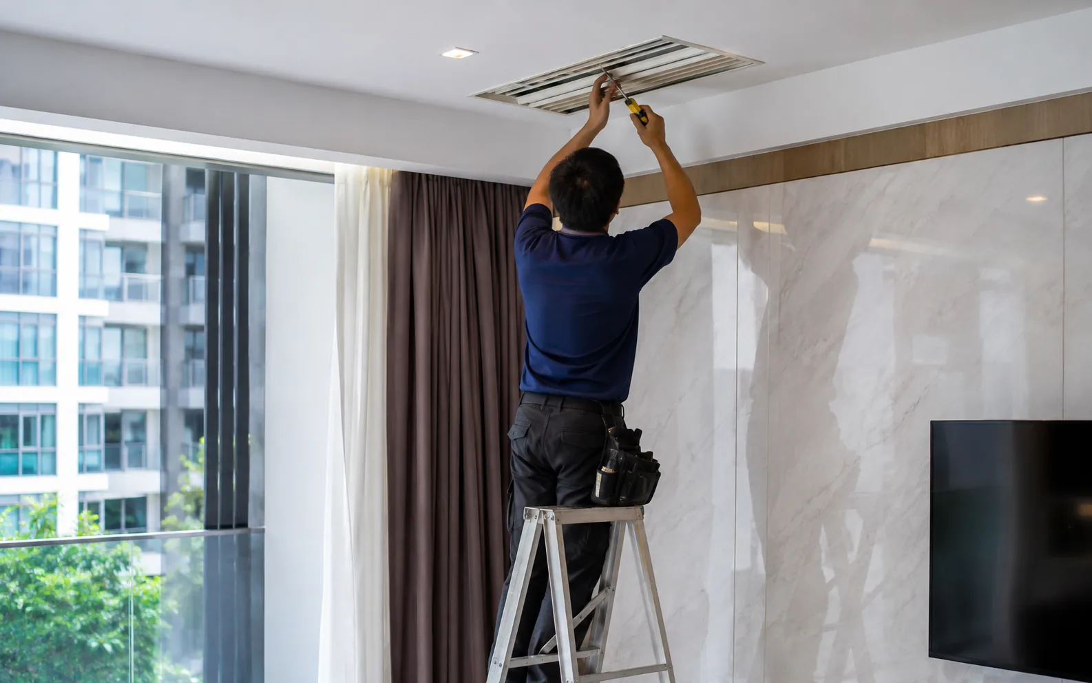 Technician carrying out HDB maintenance in Singapore.