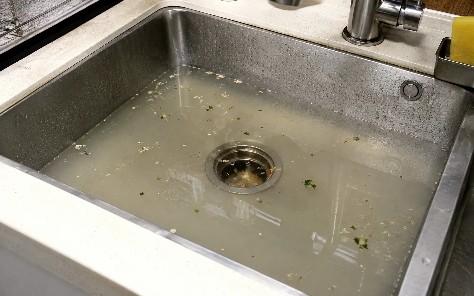 Sink drainage area requiring choke clearing in Singapore.