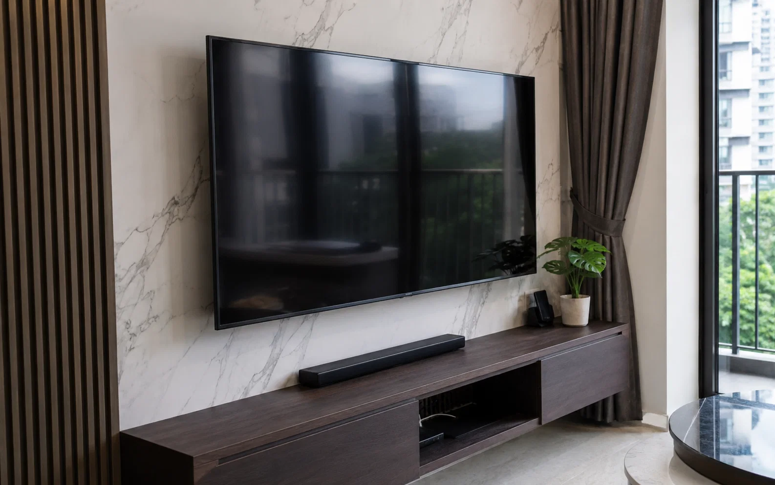 Wall-mounted TV bracket installation in a Singapore home.