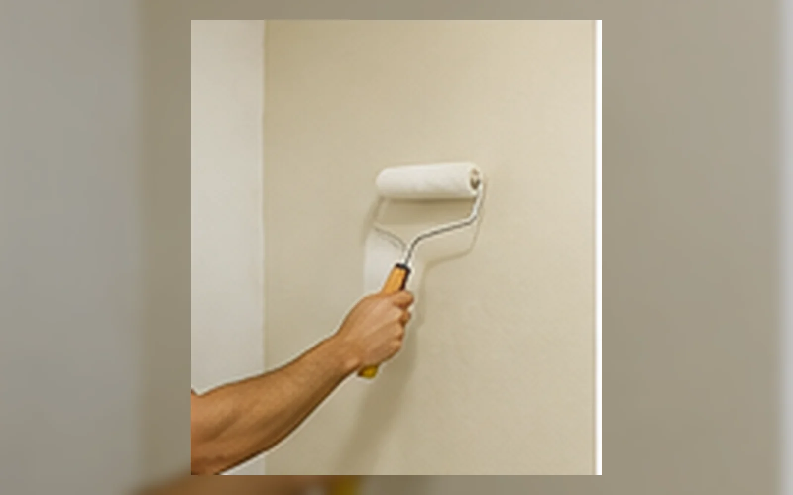 Painter repainting a wall in Singapore.