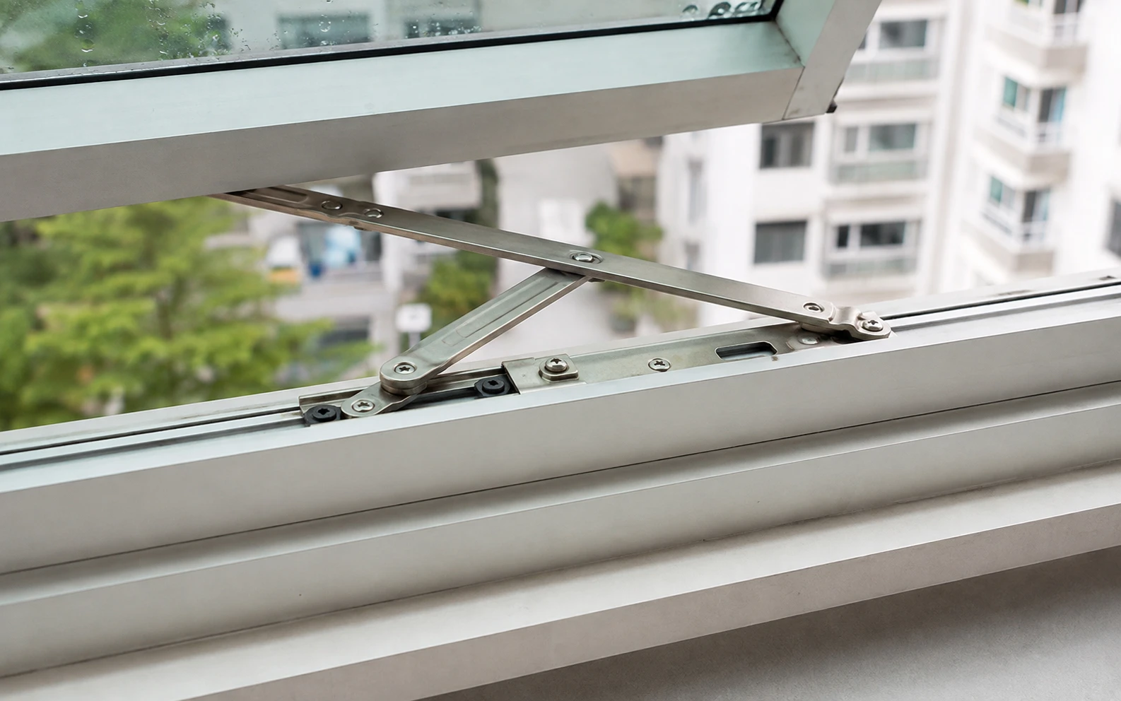 Technician repairing a window lock in Singapore.