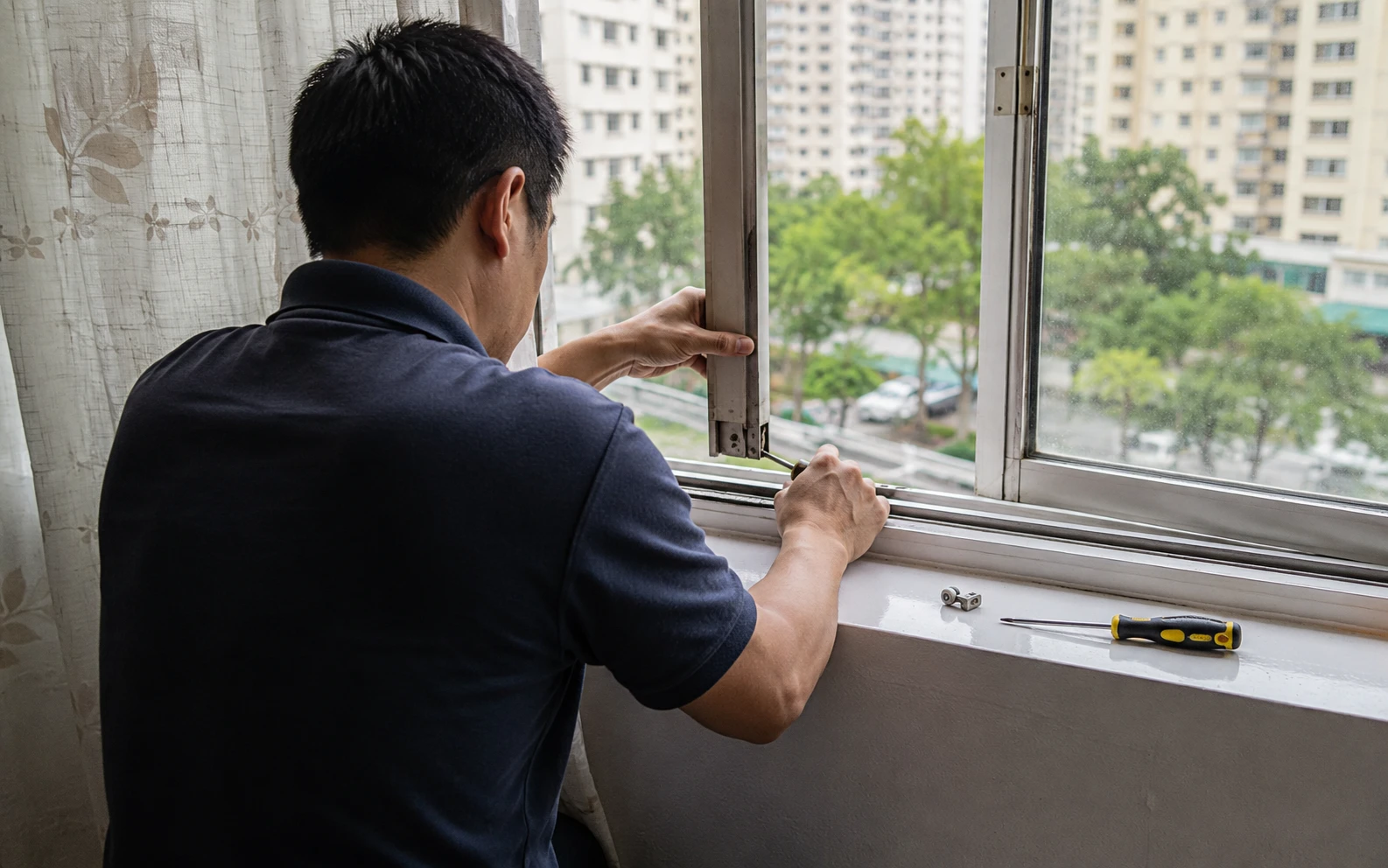 Sliding window roller and track detail in a Singapore home.