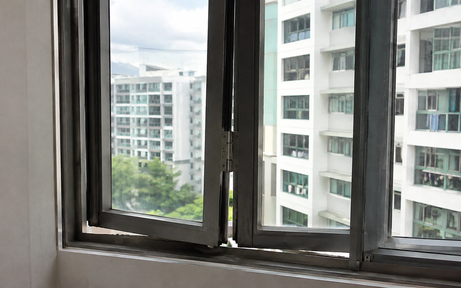 Technician replacing a window roller in Singapore.